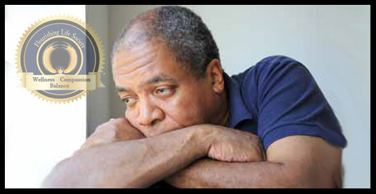 Man leaning forward, experiencing sorrow. A Flourishing Life Society article on cause of sorrow