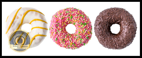 Three different colored donuts. A Flourishing Life Society article on nutrition--empty calories
