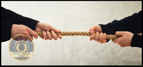 A tug a war between a man and woman representing struggle over power. A Flourishing Life Society article on gender inequality.