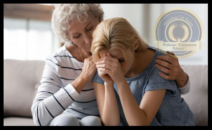 An older lady with her arms around her adult daughter. An article on assisting a family member through addiction recovery.