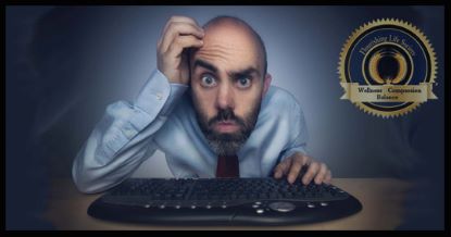 Man with confused expression at a computer keyboard, scratching his head. A Flourishing Life Society article on uncertainty and learning