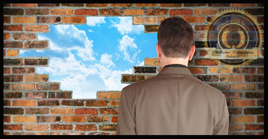 Man facing a brick wall. A hole in the wall reveals a sunny day. A Flourishing Life Society  article on working through life's difficulties.