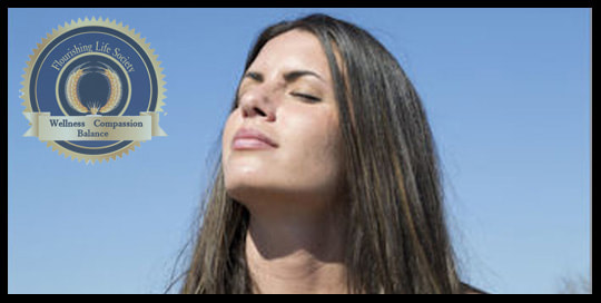 A lady holding her face to the sun. A Flourishing Life Society article on Mindfulness. Comforting unpleasant emotions.
