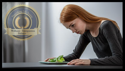 A thin girl depressed, looking at a salad. A Flourishing Life Society article on negative self talk.