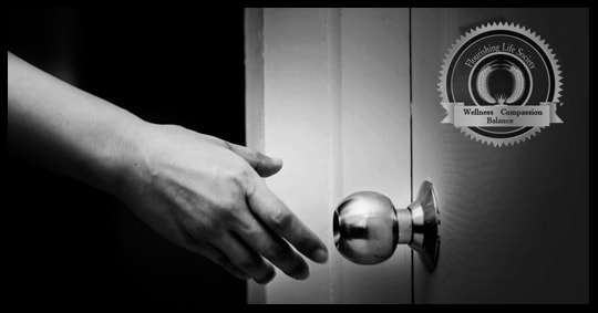 A hand reaching for a door knob. Changing Course. Leaving the old to open opportunity for the new.