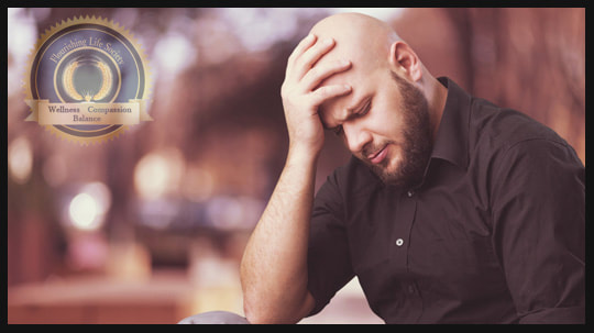 Man holding his head. Flourishing Life Society article on recovering from addiction.