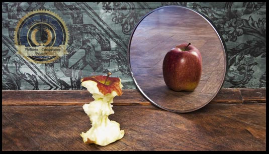 An eaten apple in front of a mirror that reflects a whole apple. An article on self-deception. 