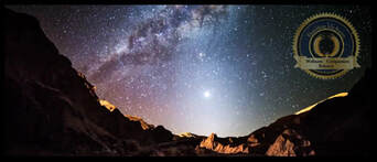 A clear starry night over desert mountains. A Flourishing Life Society article on awe