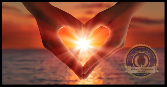 Heart hands around sun. A Flourishing Life Society article on Self Kindness