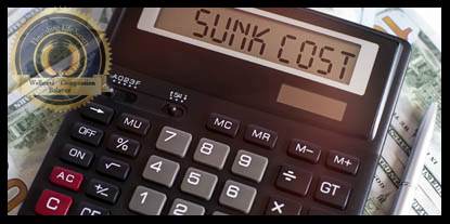A calculator on a bedding of dollar bills. A Flourishing Life Society definition of 