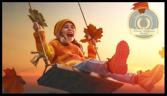 A girl laughing on a swing. Sustainable Happiness. A flourishing Life Society Article
