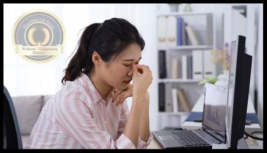 Women struggling in front of computer.