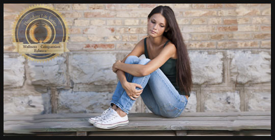 Young woman sitting on bench contemplating. A Flourishing Life Society article on acceptance.