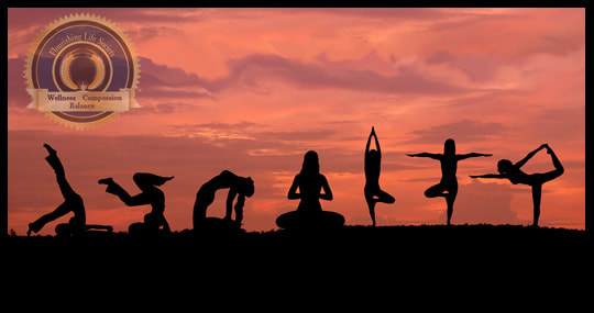 Silhouettes of several people in yoga poses against a sunset sky. Yoga and Mental Health. A Flourishing Life Society article 